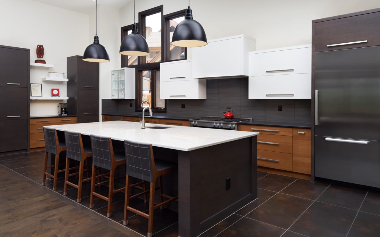 Modern geometric kitchen with a mixture of wood finishes along with grey and white cabinetry.
