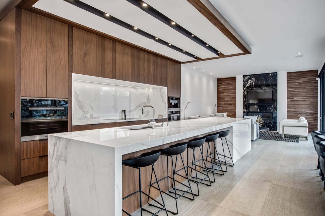 Contemporary kitchen with oversized white poreclain island with breakfast bar seating.